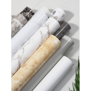 A roll of self-adhesive marble-patterned contact paper.