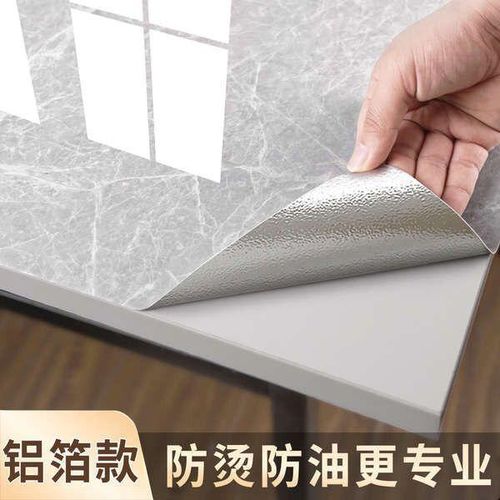 A roll of self-adhesive marble-patterned contact paper.